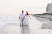 wpid3135-Bride-and-groom-holding-hands-and-walking-in-the-edge-of-the-ocean-Ocean-Isle-May-06-2012.jpg
